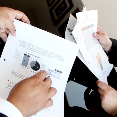 pexels-photo-259006-259006 A business team reviewing charts and graphs on documents, emphasizing data analysis and teamwork.